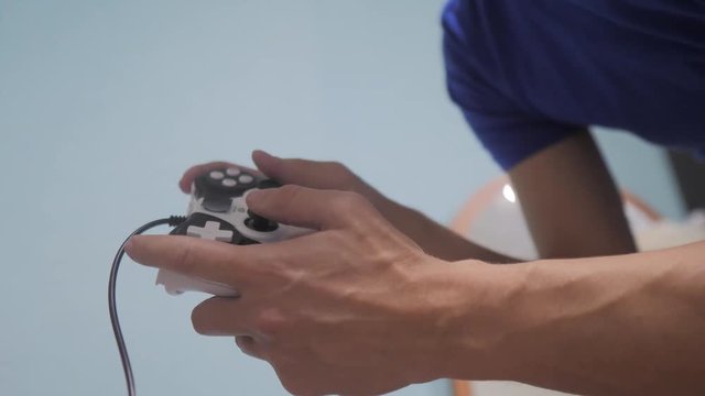 man concept playing gamepad hands video console on tv. Gamer play game with gamepad controller. Hand hold new joystick playing video console on tv. Gaming lifestyle man holding simulator joypad