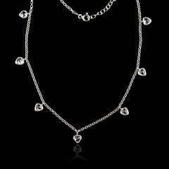 Silver necklace isolated on black background with reflection