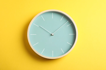 Big beautiful stylish clock on yellow background, space for text