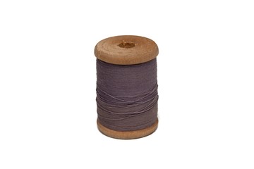 Wooden coil with thread on a white isolated background