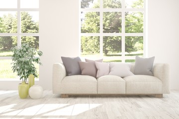 White stylish minimalist room with sofa and summer landscape in window. Scandinavian interior design. 3D illustration
