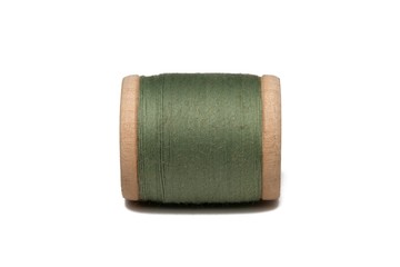 Wooden coil with thread on a white isolated background