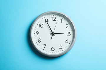 Big beautiful clock on blue background, space for text