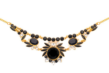 Gold jewelry with black stones on white background