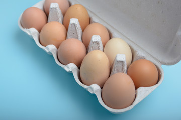 Top view close up view fresh raw chicken eggs in brown box carton purchased from the market, mart. Raw eggs are easy to buy, easy to cook, easy to eat and good health isolated background