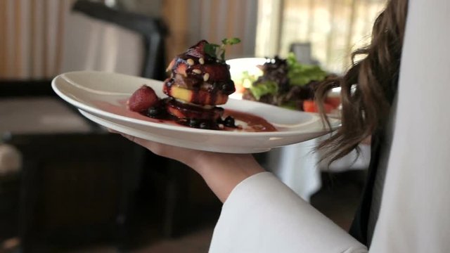 Waiter serving in motion on duty in restaurant