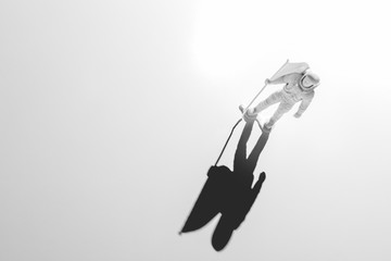 Lone Generic White Astronaut Figurine with American Flag in dramatic lighting