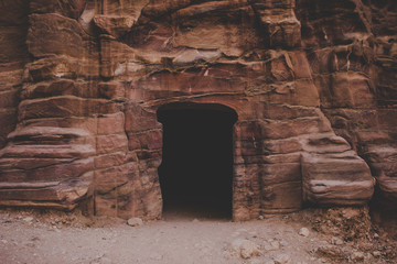 ancient door hole in mountain rock wall