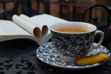 Relaxing cupof tea on the table and a book with a heart of pages. World day book