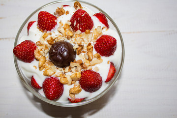 white ice cream with strawberries in a plate