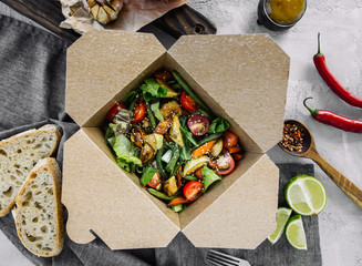 Stewed vegetables salad, carrots, tomatoes, green beans, zucchini and greens in a carton box for...