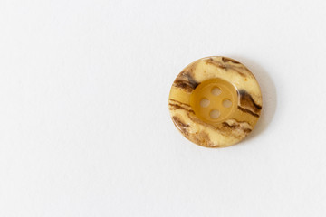 close up on button, white background