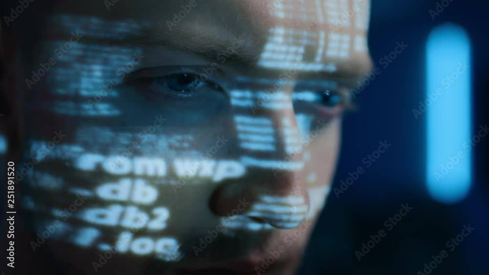Poster Portrait of Software Developer / Hacker Working on Personal Computer, Projected Moving Code Numbers and Characters Reflect on His Face. Dark Room Full of Electronics. Hacking and Programming Concept