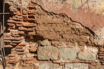 Vintage broken brick wall background. Abandoned wall detail with rich textures