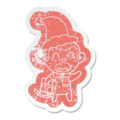 shouting cartoon distressed sticker of a monkey carrying christmas gift wearing santa hat