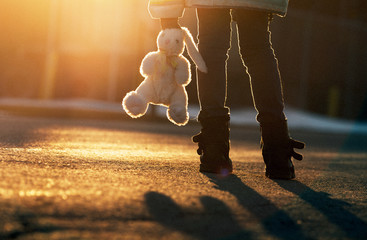 young girl holding a stuffed rabbit