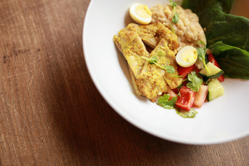 Chicken curry with salad in the plate, top view