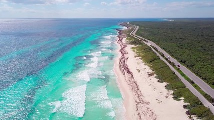 Slow aerial flyover of tropical beaches in Cozumel, Mexico.