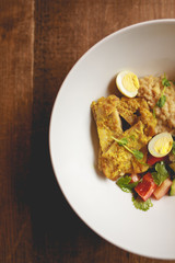 Chicken curry with salad in the half plate, top view, copy space