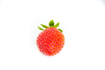 One red strawberry with leaves on white background