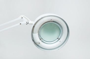 Medical lamp with magnifying glass in modern clinic