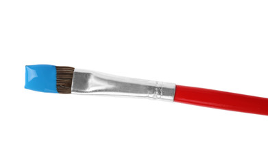 Brush with color paint on white background, top view