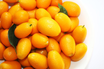 Small oranges on the white background. Nature fruits background.