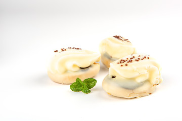 Mini yellow cakes on white background
