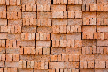 stack of red brick pattern texture, background of red brick wall, solid clay bricks used for construction