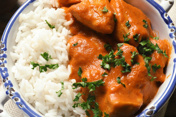 Delicious butter chicken with rice in bowl, closeup