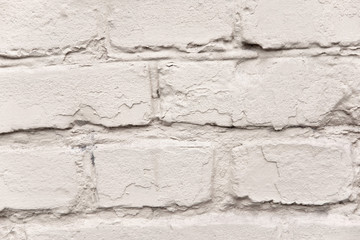 The texture of the old brick wall which is painted. Vertical photo of a brick wall. Texture for design