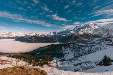 Inverse weather on sunny day in french alps with a view on Mont Blanc and fog in the valley