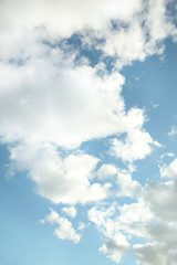 Fototapeta premium Vertical blue sky with real white clouds