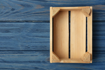 Empty wooden crate on color background, top view with space for text
