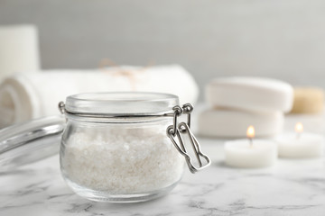 Obraz na płótnie Canvas Jar of aromatic salt on marble table. Space for text