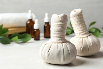Obraz na płótnie Canvas Herbal bags for spa massage on table