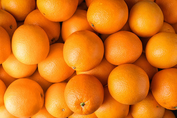Pile of fresh ripe oranges as background, top view