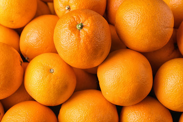 Pile of fresh ripe oranges as background, top view