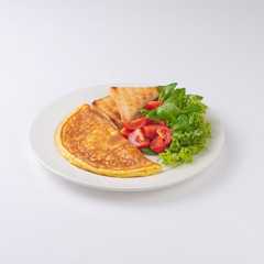 Plate of breakfast with omelette, toasts, tomato isolated on white backgound