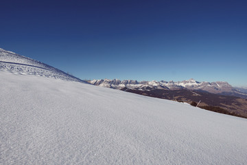 Fresh powder snow and French Grenoble Alps in the background