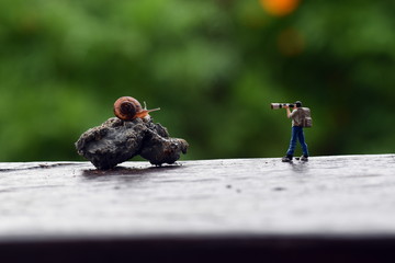 Miniature Figure Photographer take a picture small snail