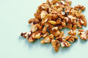 a handful of walnuts on a blue background