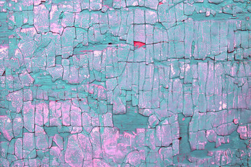 Old wooden background with remains of pieces of scraps of old paint on wood. Texture of an old tree, board with paint, vintage background peeling paint. 