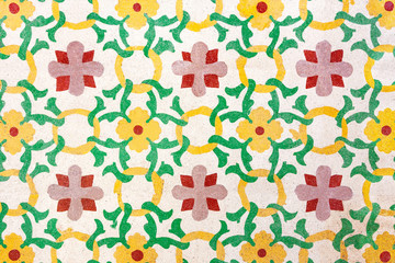 Typical old Colourful Maltese Tiles in yellow, red and green color on the floor. Flower Ornament