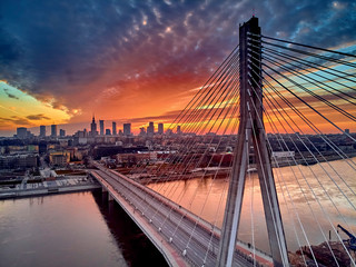 Fototapeta Beautiful panoramic aerial drone sunset view to Warsaw city center with skyscrapers and Swietokrzyski Bridge (En: Holy Cross Bridge) - is a cable-stayed bridge over the Vistula river in Warsaw, Poland obraz