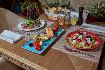 catering table set service with silverware and glass stemware at restaurant before party