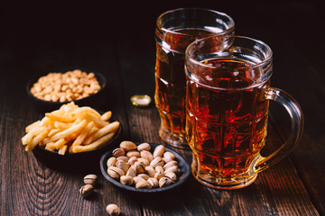 beer and snacks. friday party atmosphere, craft brewery, bar table. restaurant, pub, food concept. delicious lager drink, fries and salted nuts