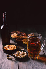 beer and snacks. friday party atmosphere, craft brewery, bar table. restaurant, pub, food concept. delicious lager drink, grilled sausages and salted nuts