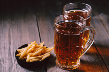 lager beer and snacks. bar table. restaurant, pub, food concept. delicious drink and french fries. friday party atmosphere, craft brewery background