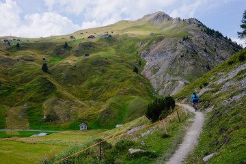 Mountain biker riding on a mtb trail in the mountains near Livigno Italy